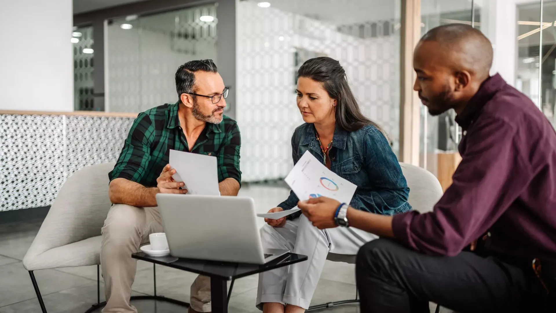 Casual meeting of a business team analyzing financial data.